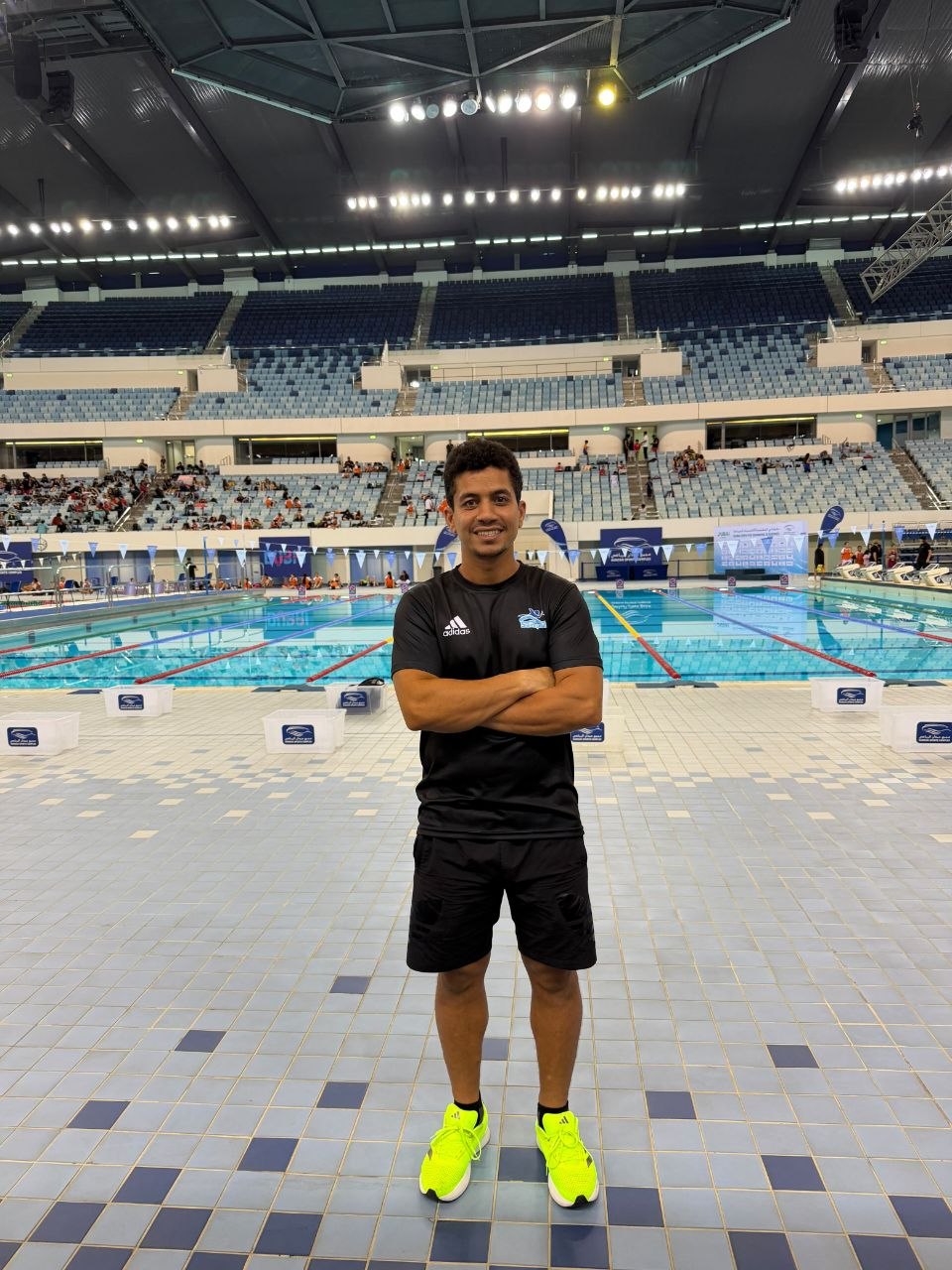Coach and swimmer at an indoor pool